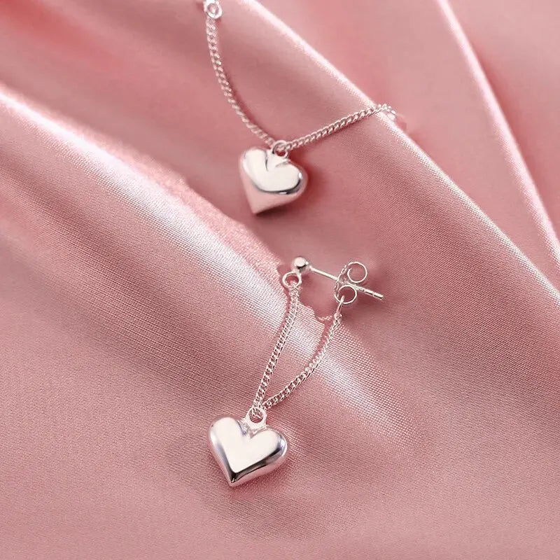 Boucles d’oreilles argentées pendantes avec pendentif cœur – bijou raffiné femme
